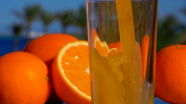 特写美味的橙汁倒入玻璃杯视频素材