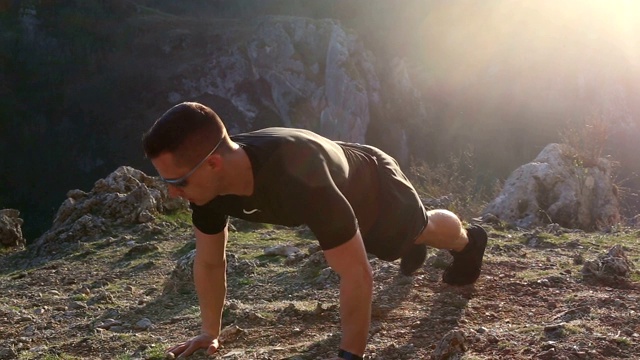 一个年轻人在山顶上锻炼视频素材