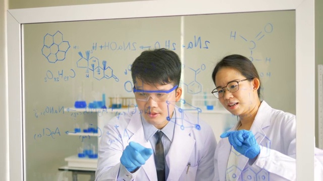 两名科学家在实验室中使用透明玻璃板化学品视频下载