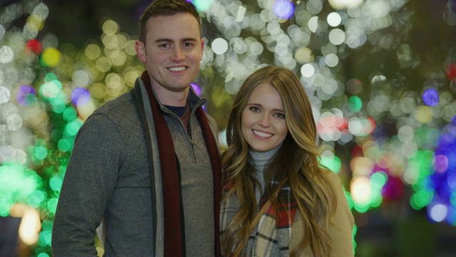在圣诞树附近，一对幸福的夫妇对着照相机微笑的肖像/普罗沃，犹他州，美国视频素材