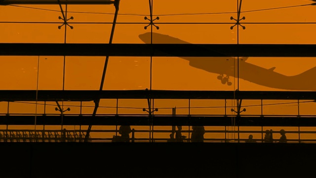 剪影游客和飞机在机场航站楼起飞视频素材
