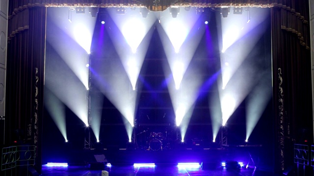 音乐会前空旷的舞台上闪烁着白色和蓝色的美丽光芒。视频素材