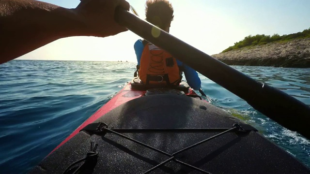 一个人在一个阳光明媚的日子里划着双人海上皮划艇视频素材