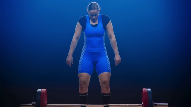 女子举重运动员在抓举比赛中举起杠铃视频下载