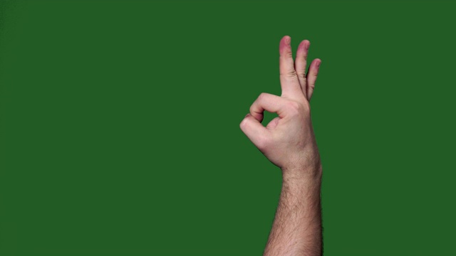 Chromakey。绿色的屏幕。男人的手做得很好。视频素材