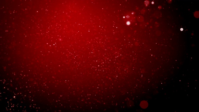红色圣诞背景上飘落的五彩纸屑和散景灯。视频素材