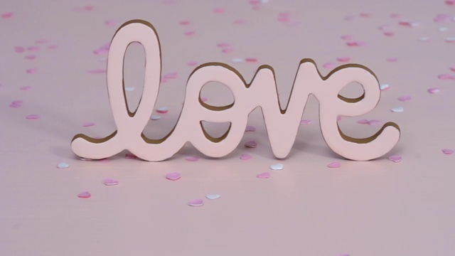 情人节的爱情标志在粉红色的背景上。视频下载
