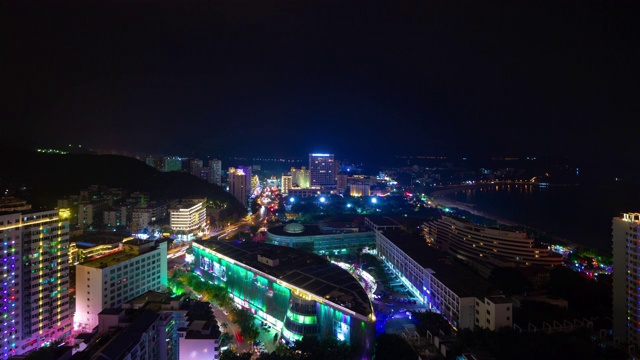 夜晚照亮三亚著名的大东海海滩小镇屋顶全景4k时间推移海南岛中国视频素材