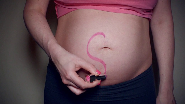 妈妈用口红在怀孕的肚子上画了一颗心视频素材