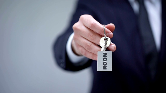 房间字上钥匙链在男手上，为出差提供出租房屋服务视频下载