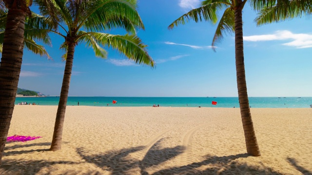 阳光明媚的一天三亚著名的大东海海滩全景4k时间推移海南岛中国视频素材