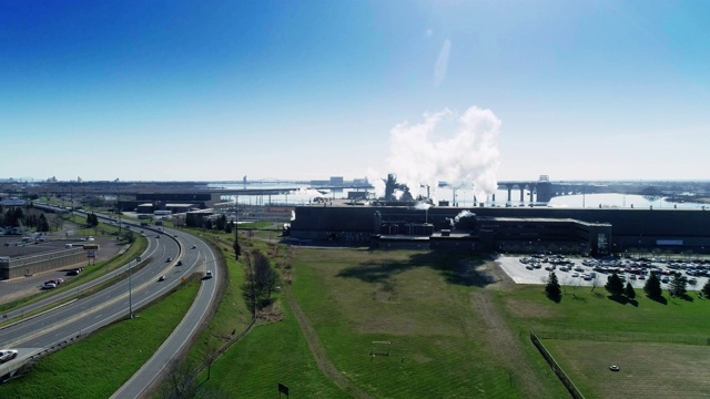 工业是否意味着污染?该工厂位于明尼苏达州五大湖之一的苏必利尔湖岸边。带有上升摄像机运动的无人机视频。视频下载