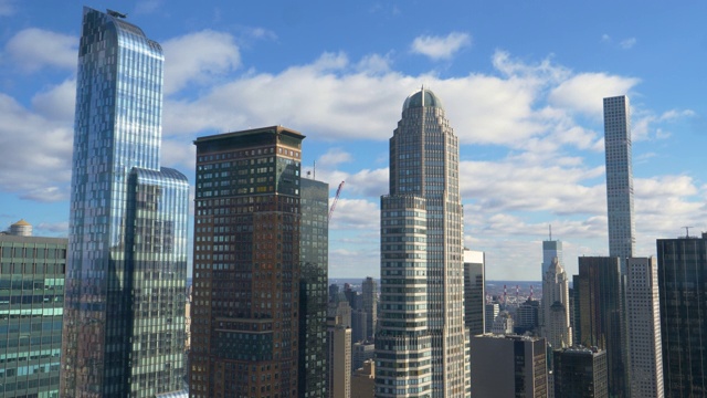 在一个阳光明媚的日子里，曼哈顿的现代玻璃摩天大楼令人叹为观止。视频下载