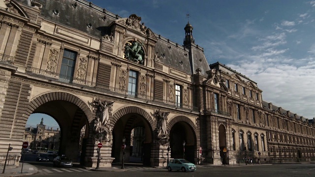 法国巴黎，弗朗索瓦·密特朗码头上的卢浮宫博物馆façade上的交通经过和拱门前的时间流逝视频下载