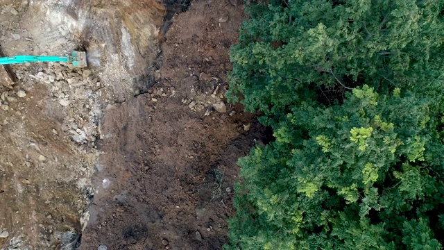 无人机拍摄的森林砍伐鸟瞰图。施工道路上的热带雨林视频下载