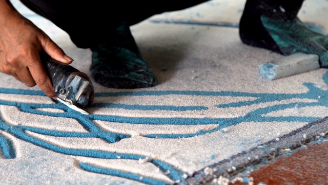 工人使用切割地毯工具手工装饰地毯。视频下载