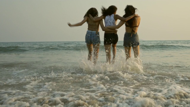 美丽的亚洲年轻女子正奔向大海。视频素材