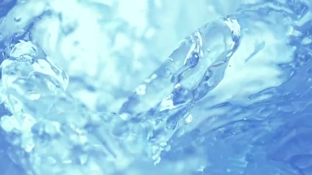 冰块落入旋转的浅蓝色海水中，产生水花和气泡，特写慢镜头视频素材
