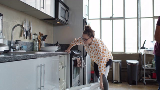 一对夫妇装洗碗机的慢动作镜头视频下载