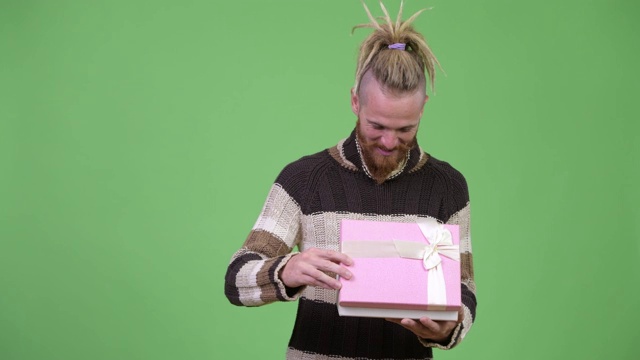快乐的大胡子男人打开礼物盒准备圣诞节视频下载