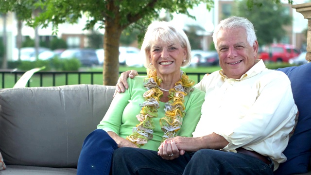 一对老年夫妇坐在户外的露台上视频素材