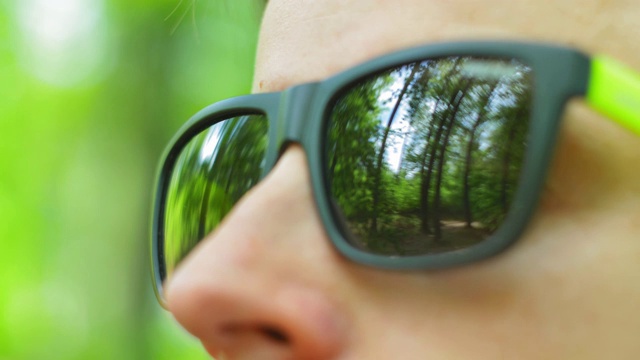 戴着墨镜的男人在森林里看近景视频下载