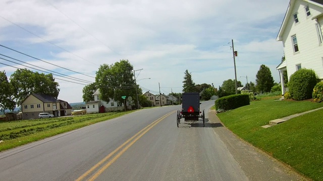 在阿米什乡村开车时，遇到两辆四轮马车视频素材