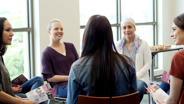 细心的女性在会议中倾听乳腺癌幸存者的声音视频素材