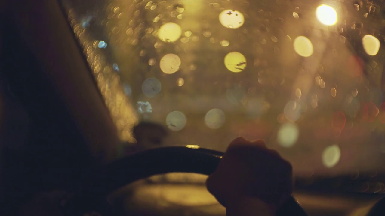 一个女人在晚上的雨中开车的照片视频下载