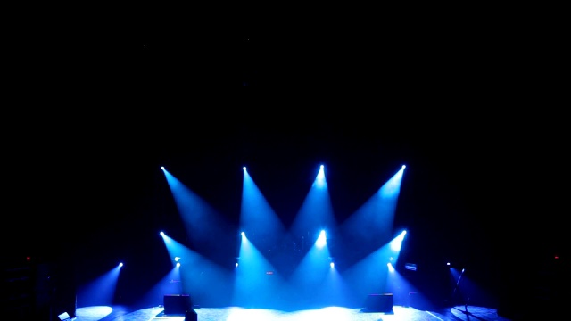 蓝色光线在黑暗中交替地在舞台上闪烁。空的音乐会舞台。视频素材