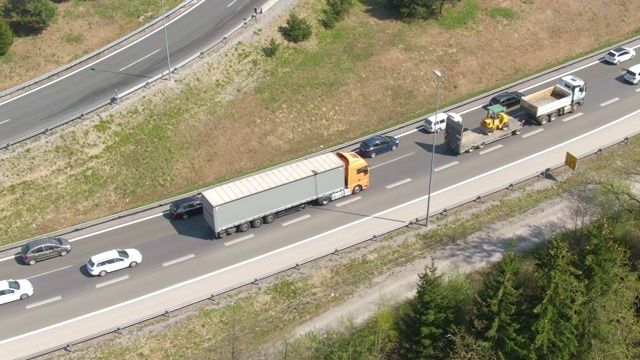 在交通堵塞期间，两辆卡车在高速公路上行驶。视频下载