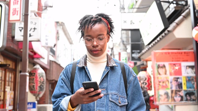 一名非洲游客在日本使用手机应用程序四处游览视频素材