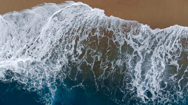 在俯视图中，海浪沿着海岸奔跑视频下载