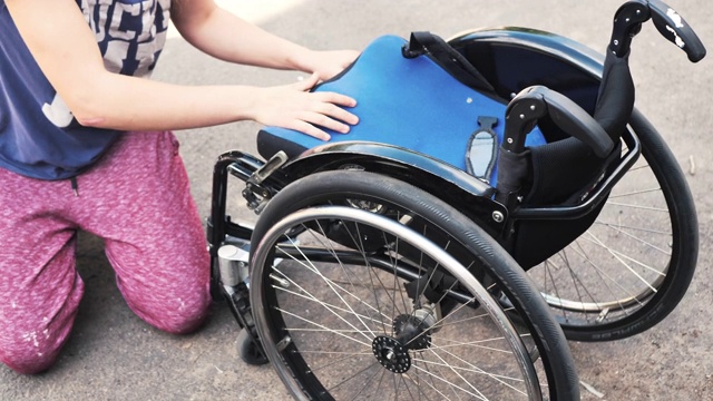 年轻女子在滑板公园轮椅-准备轮椅为特技视频下载