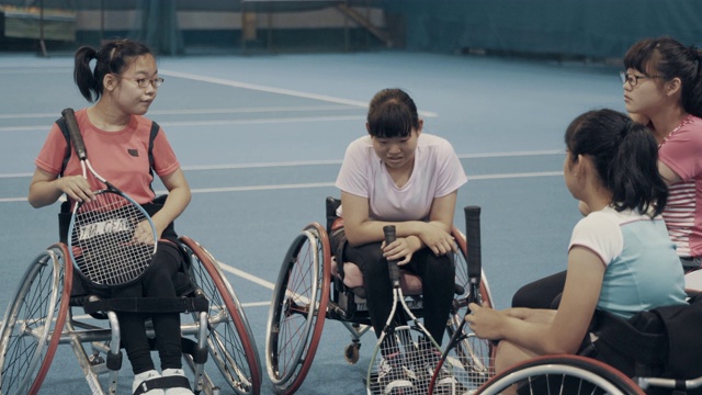 坐在轮椅上打网球的少女们在休息视频下载