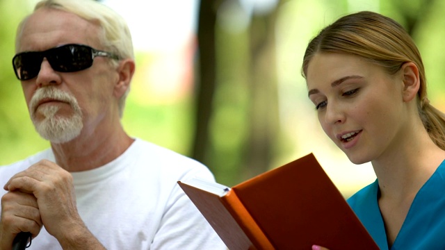 护士给盲人读书，在残疾人诊所附近休息视频素材