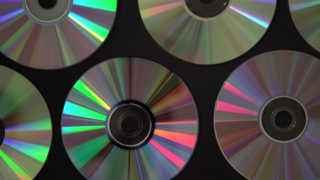 老式CD或DVD磁盘背景，旧的圆形光盘用于数据存储，共享电影和音乐视频素材