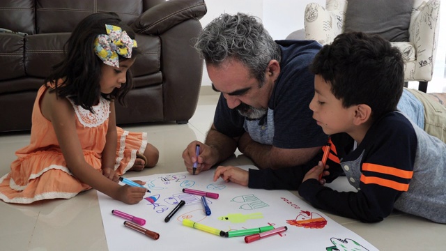 创造性的拉丁父母在家里和孩子们一起画画和大笑。视频素材