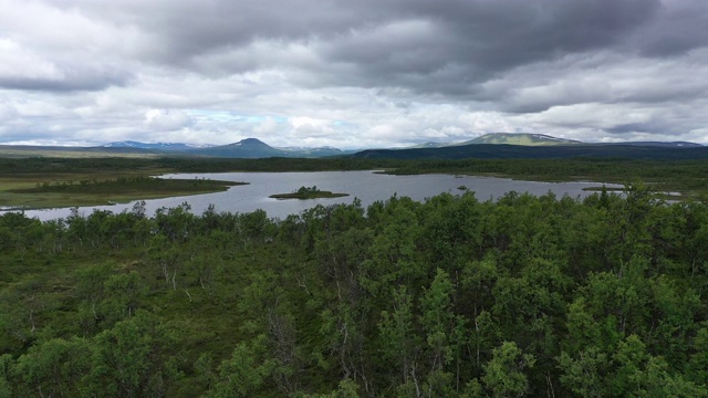 无人机视频飞过森林，飞向山上的一个湖泊视频下载