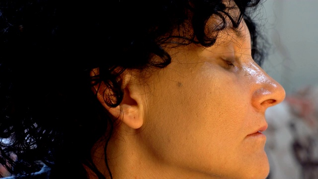 一个女人用化妆刷在脸上涂抹干燥的化妆品色调粉底的肖像视频素材