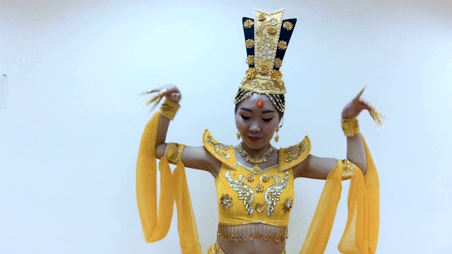 美丽的亚洲女人跳舞与手与长指甲美甲在传统的泰国黄色连衣裙视频素材