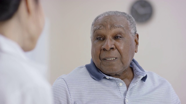 一名少数民族高级男子在与一名女医生预约时交谈视频素材