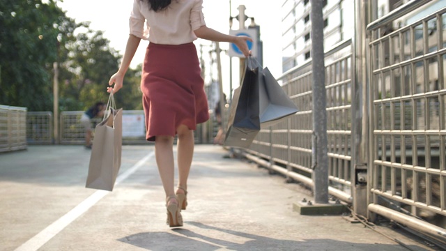 慢动作亚洲女人跳快乐购物袋购物视频素材