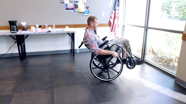 一名男性退伍军人在社区中心坐着轮椅表演特技视频下载