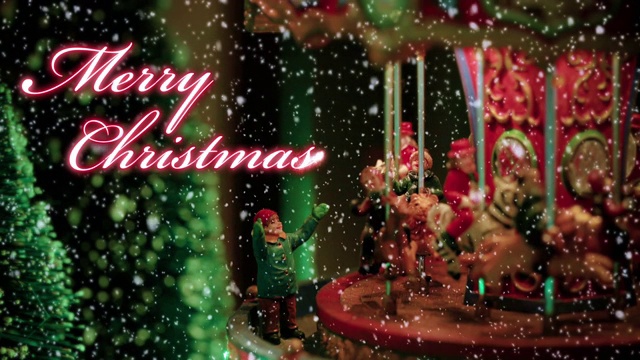 圣诞快乐文字排版设计在红色与旋转木马的玩具满灯的背景下的雪-圣诞活动的概念视频下载