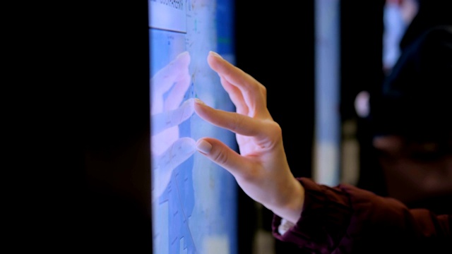 妇女使用交互式触摸屏显示与城市地图视频下载
