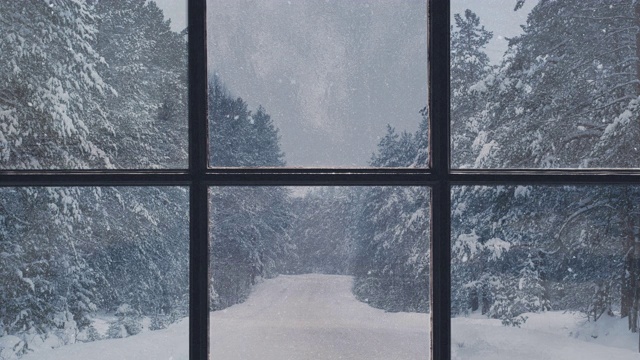 一扇俯瞰冬季森林的木窗的剪影。美丽的冬季景观与飘落的雪。视频素材