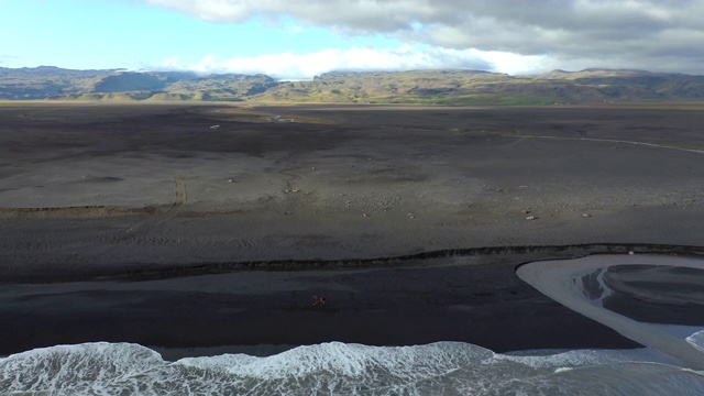 一群人在冰岛黑沙海滩的无人机自拍视频素材
