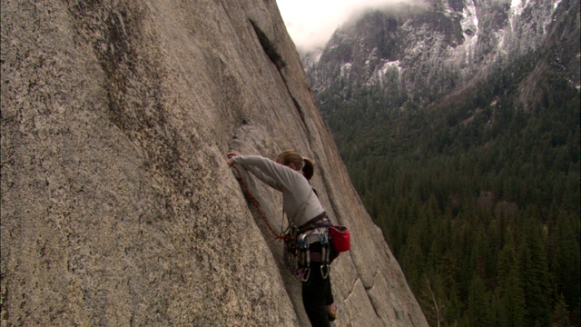 攀岩者攀登陡峭的悬崖。视频下载