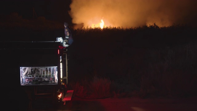 消防车在燃烧的草地上的背景视频素材